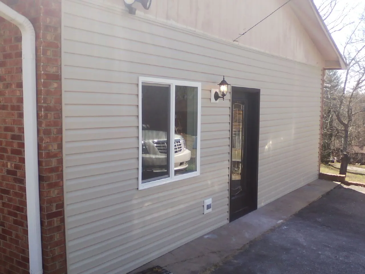 New vinyl siding and entry door on a room addition in Seminole